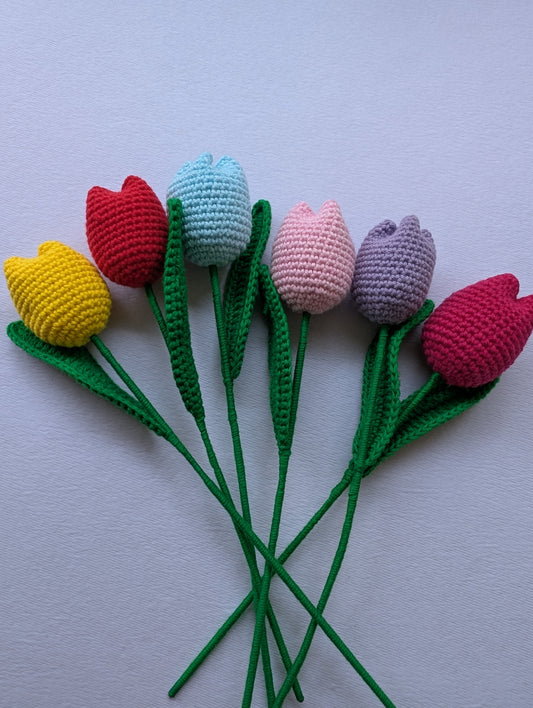 Bouquet of colorful crocheted tulips on a white background