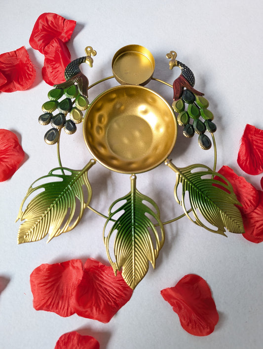 Decorative gold bowl with green leaves and red flowers on a white background